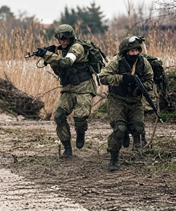 Двое военнослужащих отрабатывают выдвижение в составе группы